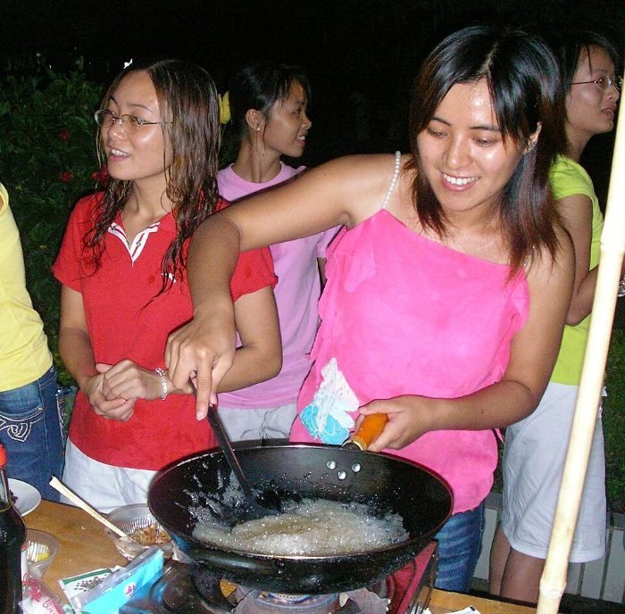 Priya in an apron next to her kitchen counter
